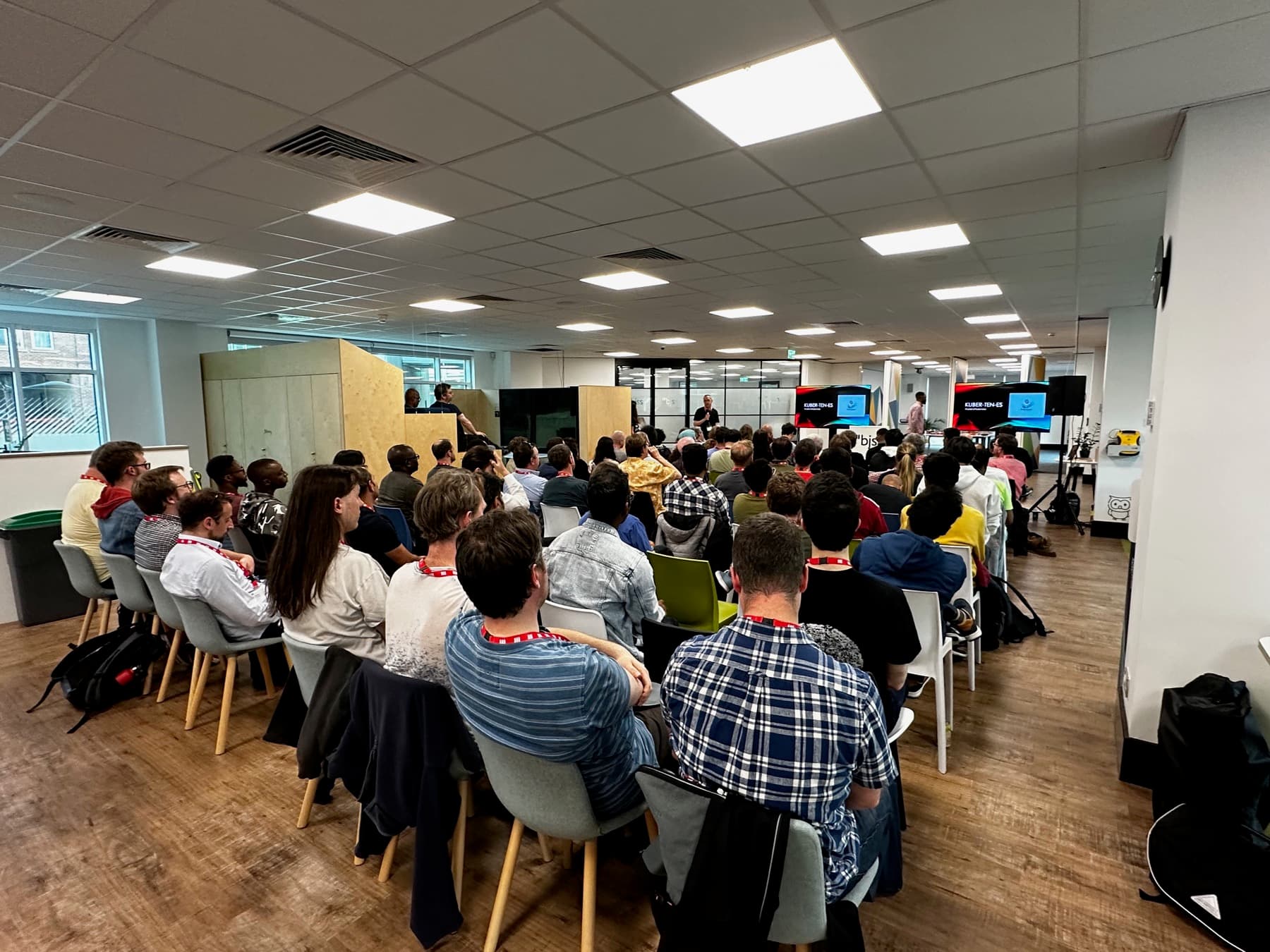 Rows of attendees in a large office event space