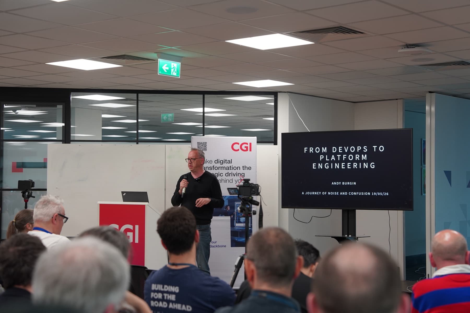 Andy Burgin presenting From DevOps to Platform Engineering beside the CGI lectern
