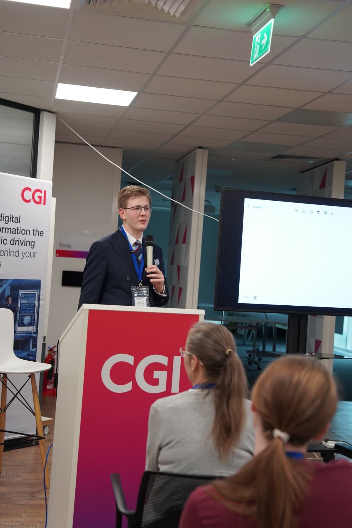 A speaker at the CGI lectern addressing the room