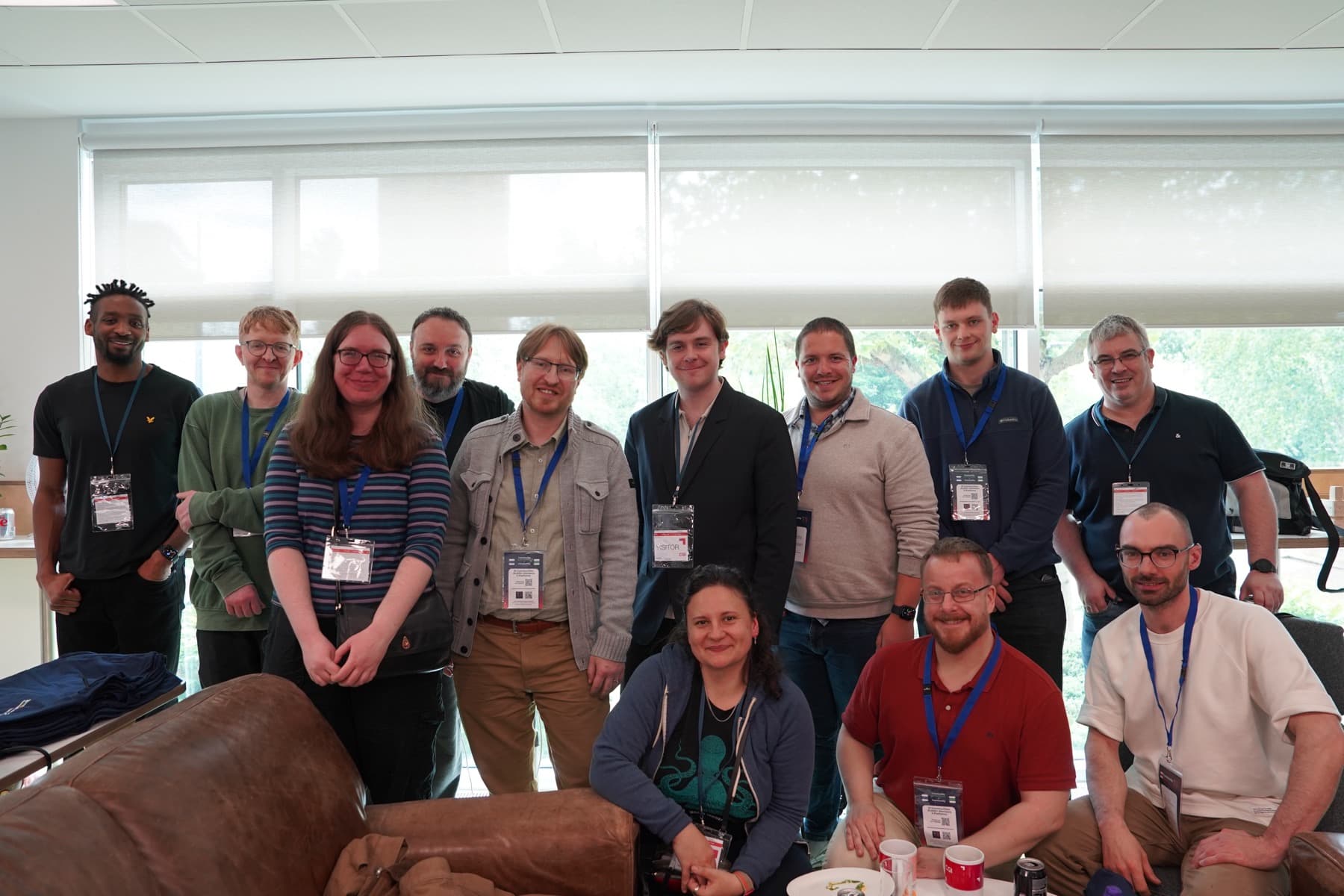 Speakers and organisers posing together with their lanyards on